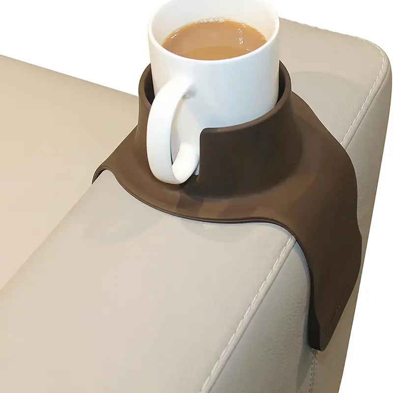 Brown CouchCoaster holding a white mug on a leather sofa arm