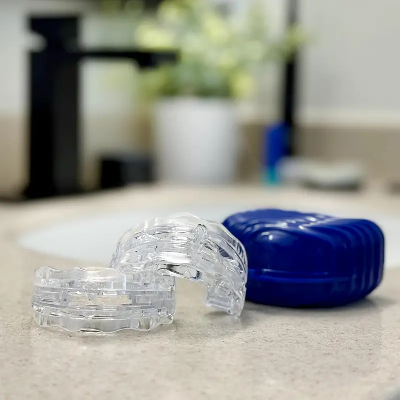 Itus Mouthguardz night guards and blue case on a bathroom counter