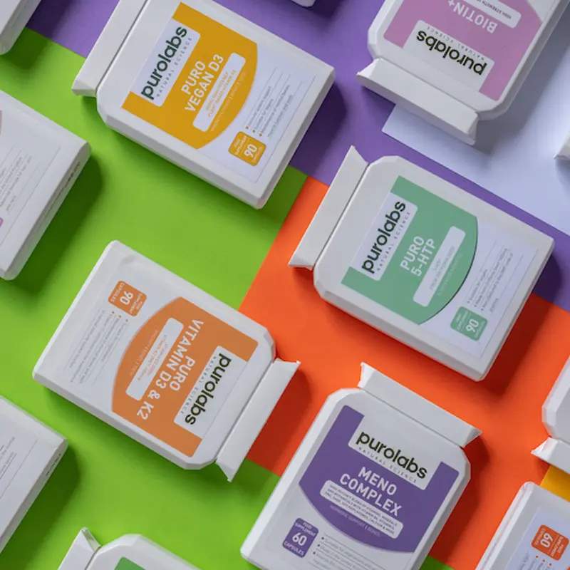 PuroLabs supplement packs laid out on colored paper